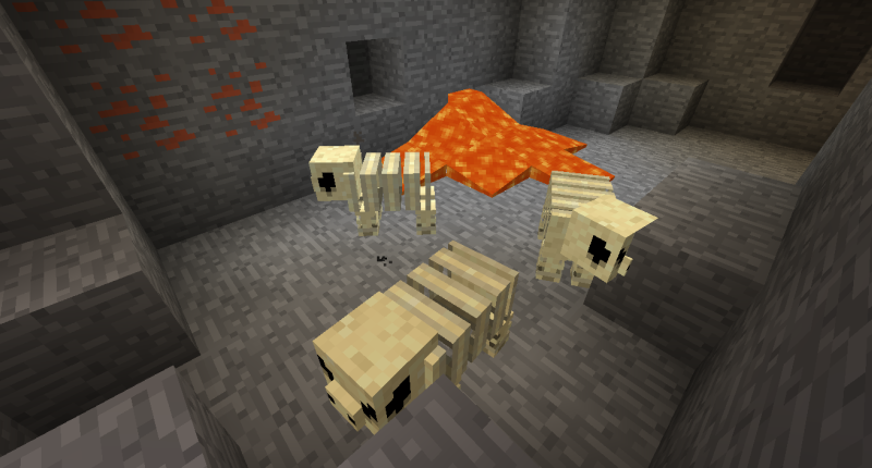 New Items and Mobs Fossil Monsters walk around near a pool of lava and some copper ore.