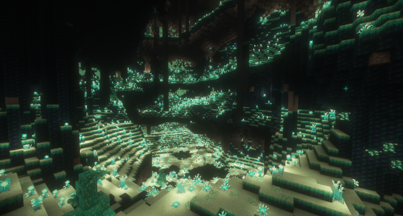 An open Glowroot Cave with tons of vertical height, and some pillars hanging from the ceiling.