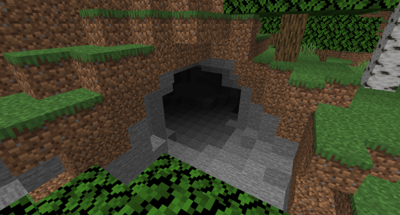 A cave entrance within a forest.